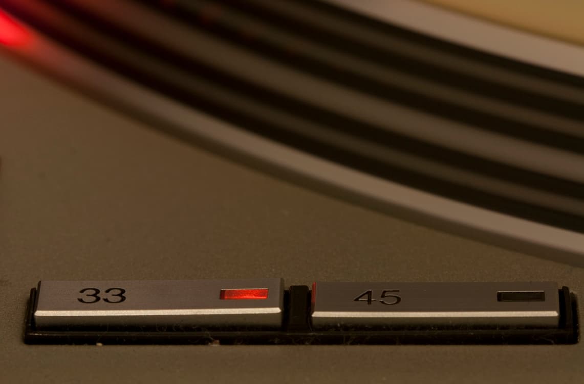 The 33 and 45 speed buttons on a Technics SL-1200-series deck.